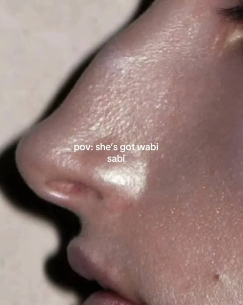 Close-up of a person's nose and lips with the text "pov: she's got wabi sabi".