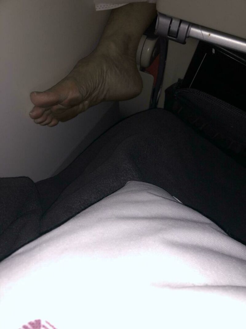 Photo of a person's foot hanging over the edge of a seat.