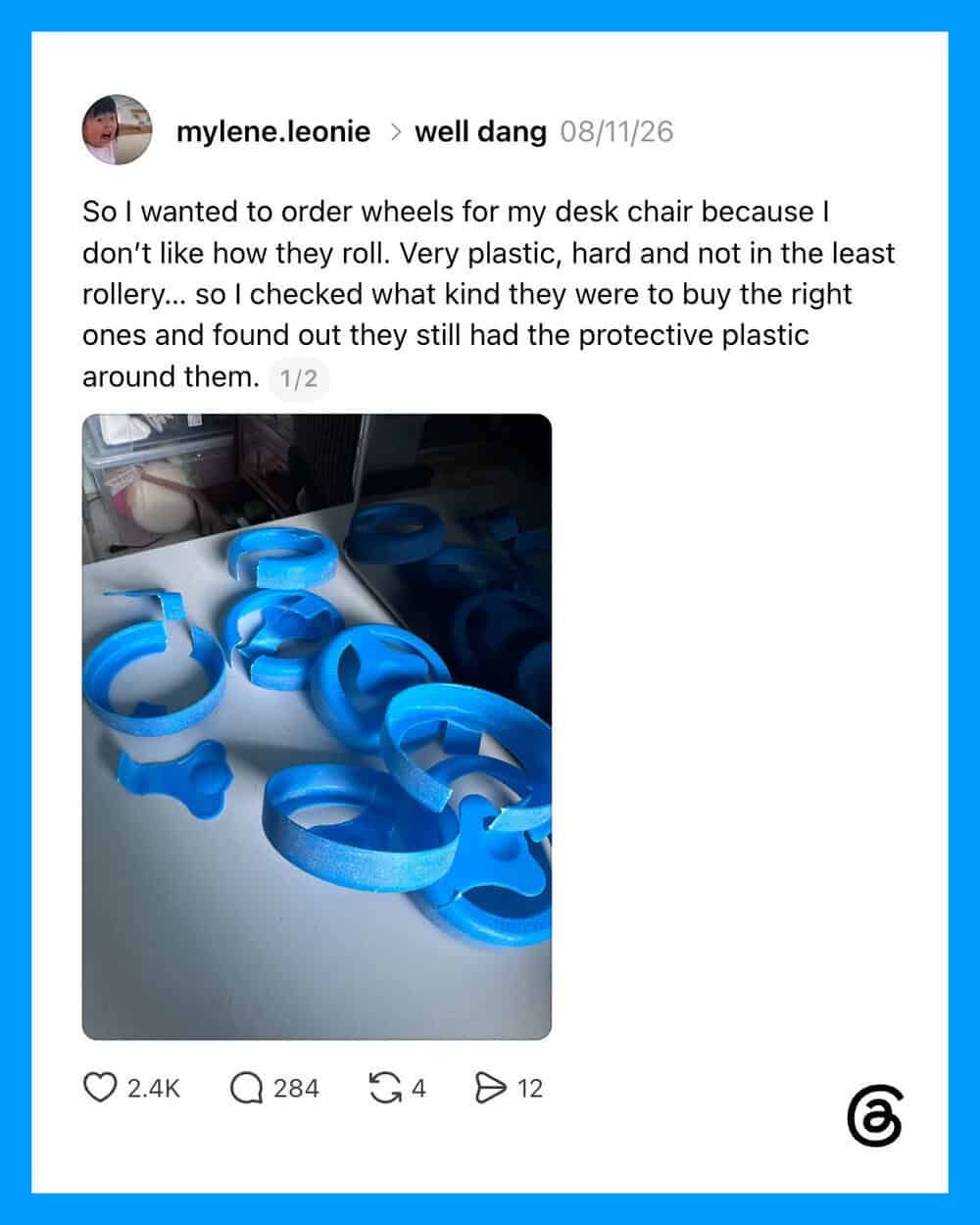 Blue plastic wheel-shaped desk chair wheels with protective plastic around them.