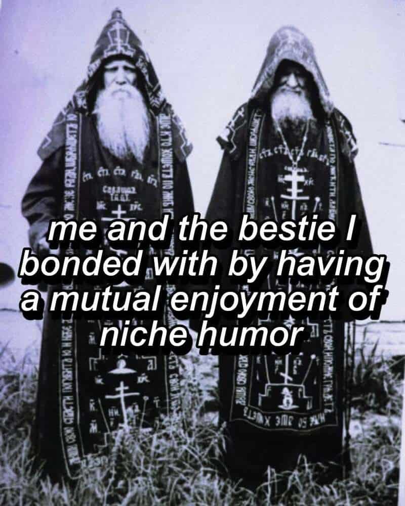 Two men dressed as wizards with long beards and robes, standing outdoors.