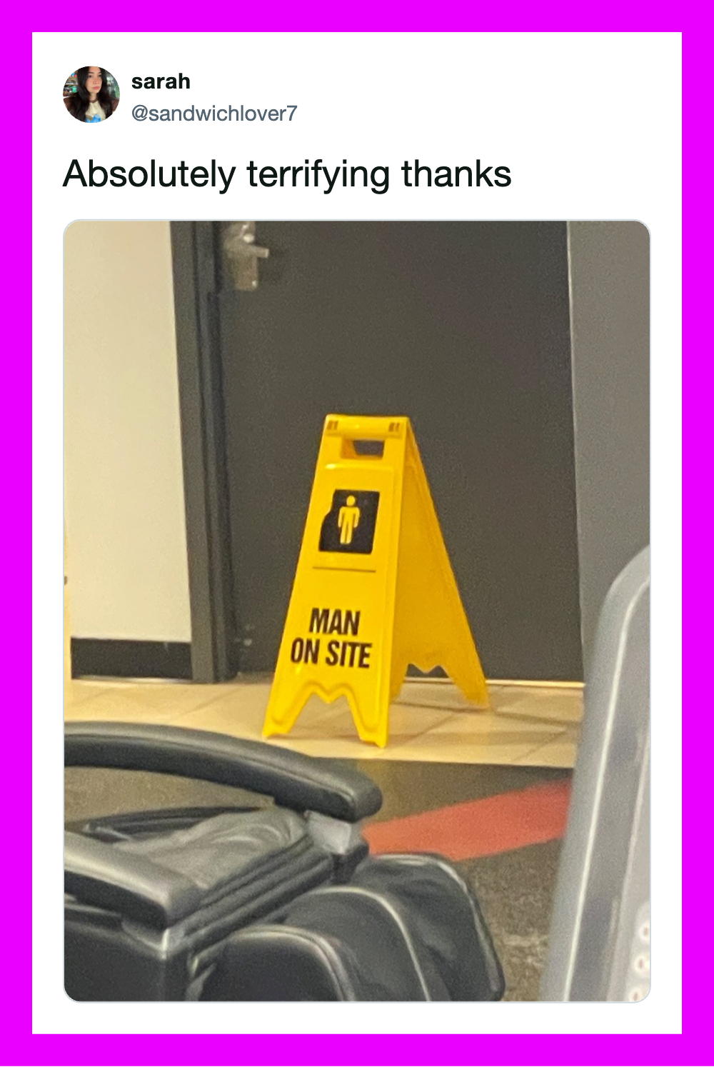 Yellow 'Man on Site' caution sign in front of a door, with luggage nearby.