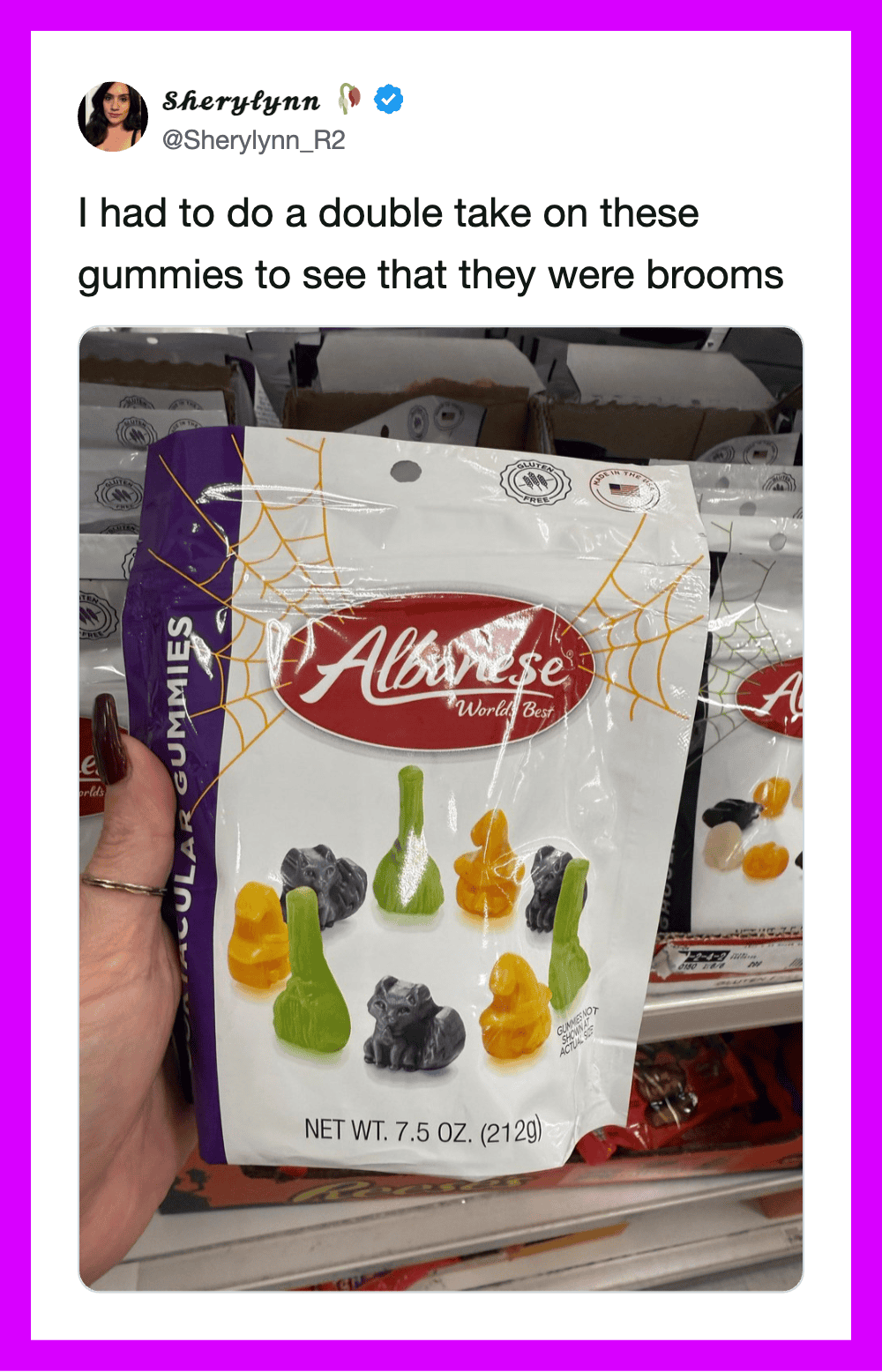Woman holding a bag of Albrowse gummies with a spider web design on the package.