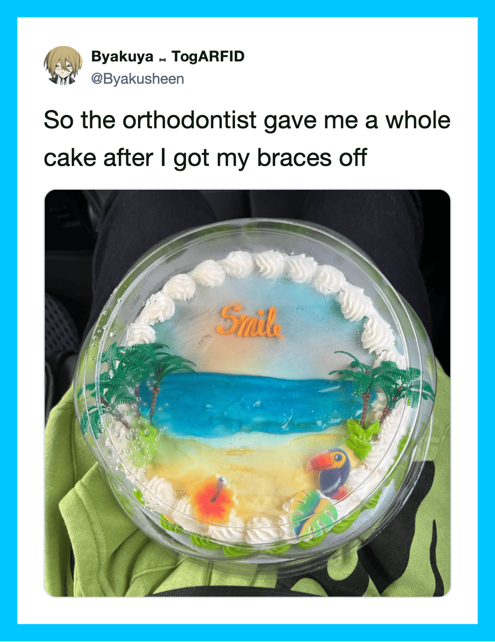Cake with ocean scene, palm trees, and the word 'Smile' on top.