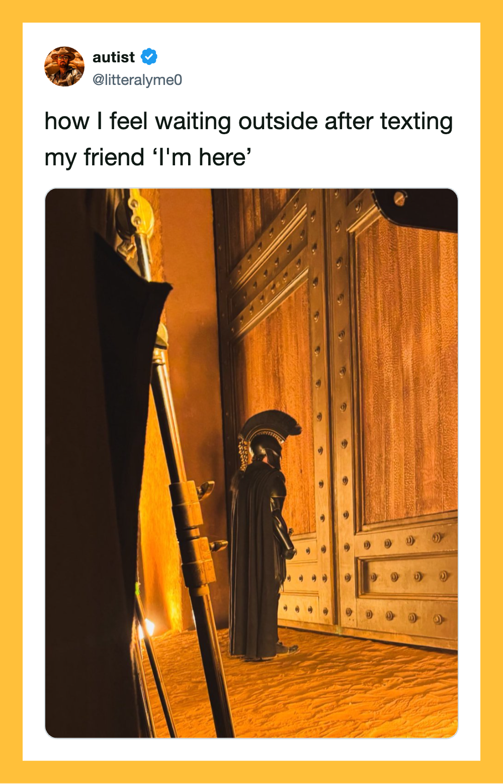 Waiting outside for friend after texting 'I'm here' with a wooden door and a statue.