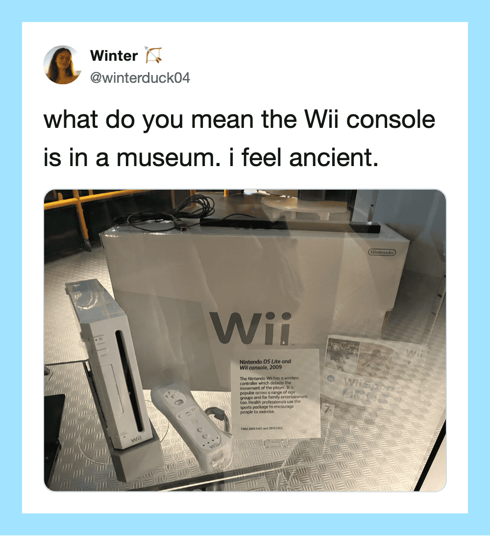 Wii console in a museum with a sign and controllers, feeling ancient.