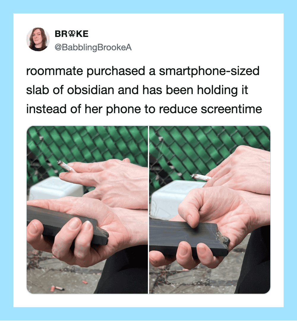 Photo of a hand holding a smartphone-sized obsidian slab with a cigarette on top.