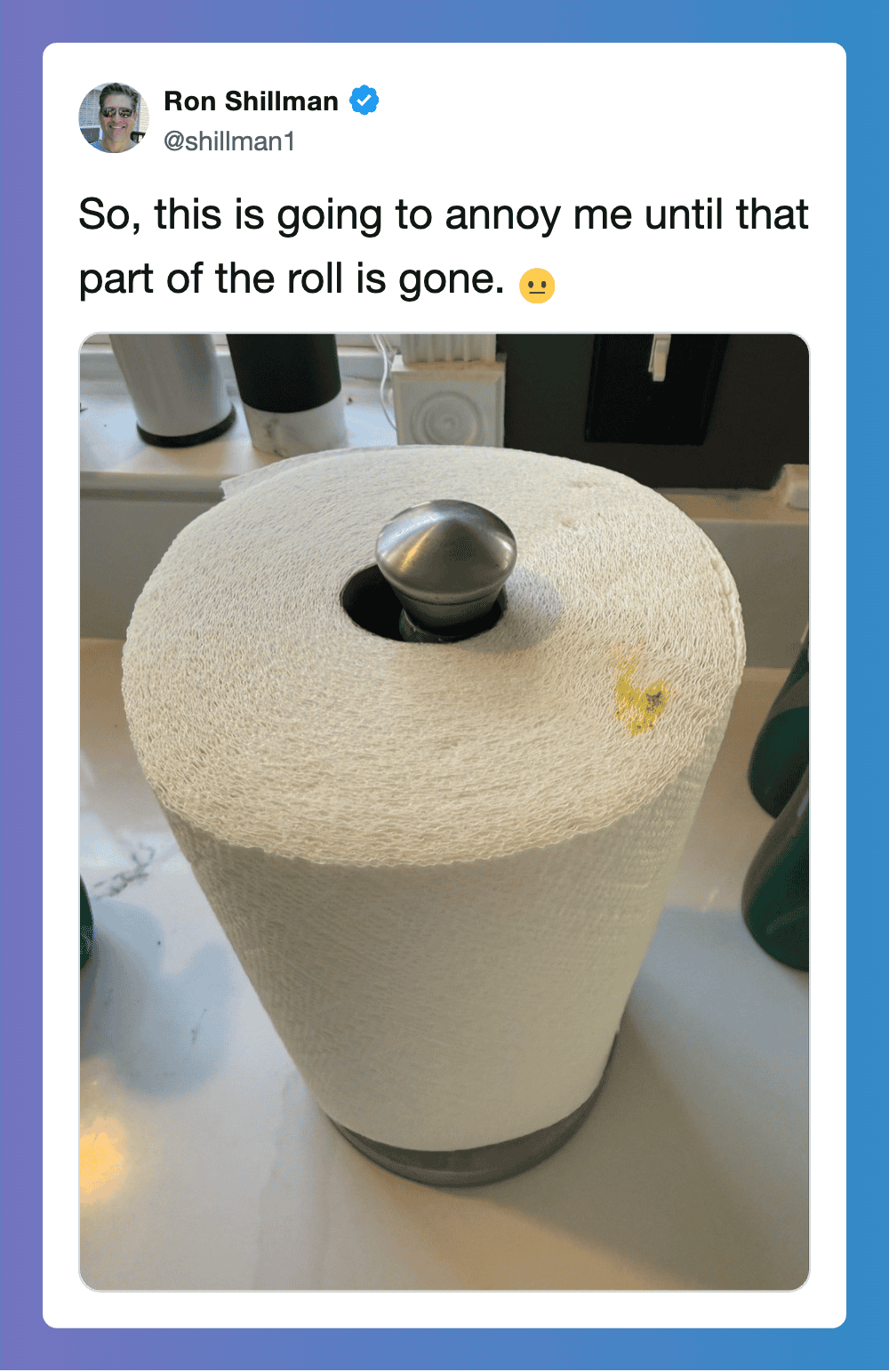 A roll of paper towel with a metal ball on top, part of the roll is missing.