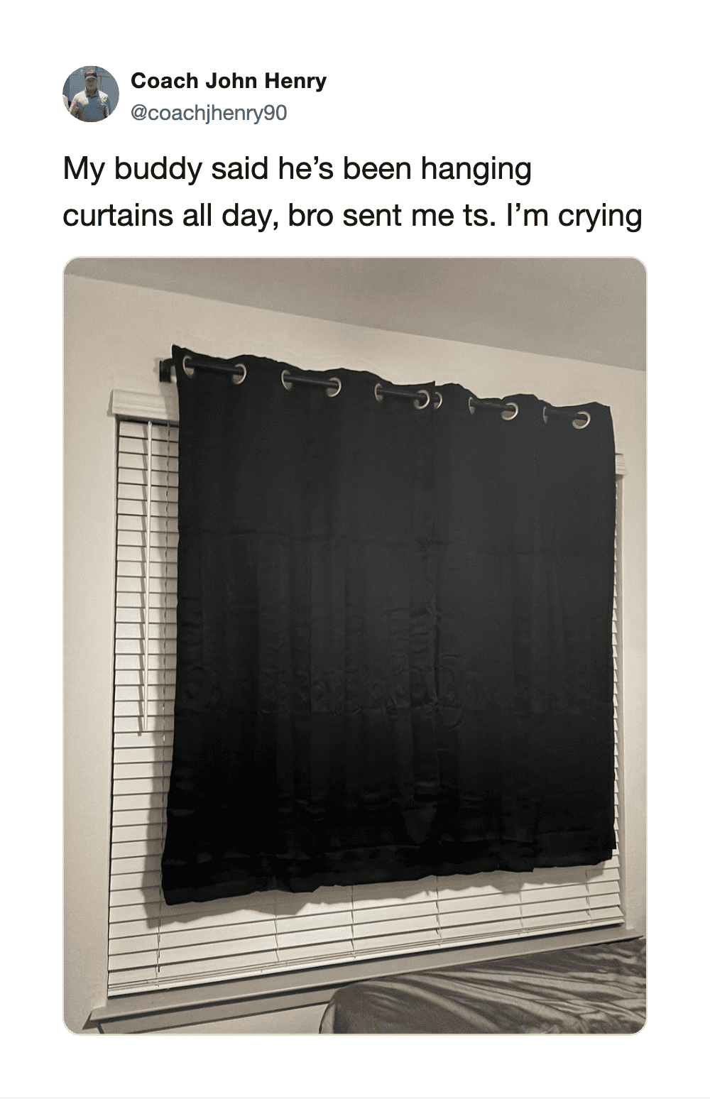 Curtains hanging on a window with a tweet about crying.