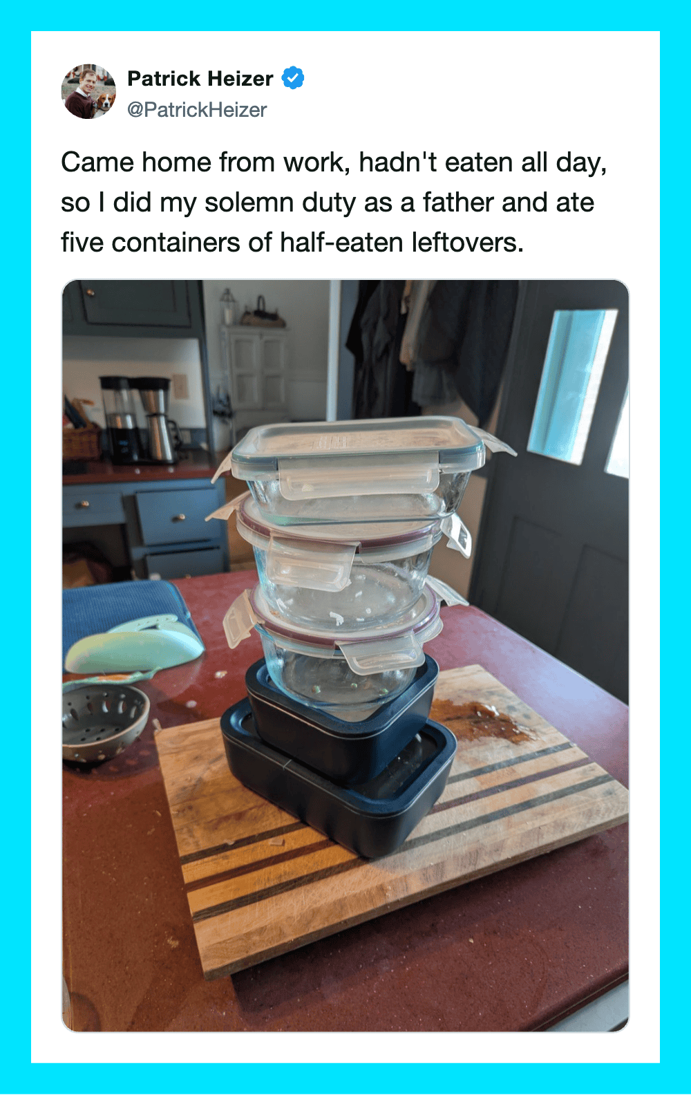 Stack of five leftover food containers on a wooden cutting board in a kitchen.