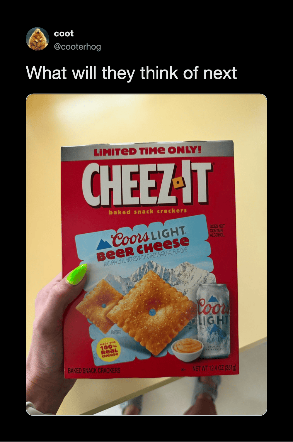 Person holding a box of Cheez-It baked snack crackers with beer cheese flavor.