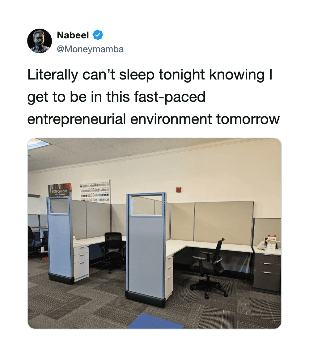 Empty office cubicles with chairs and desks in a modern workspace.