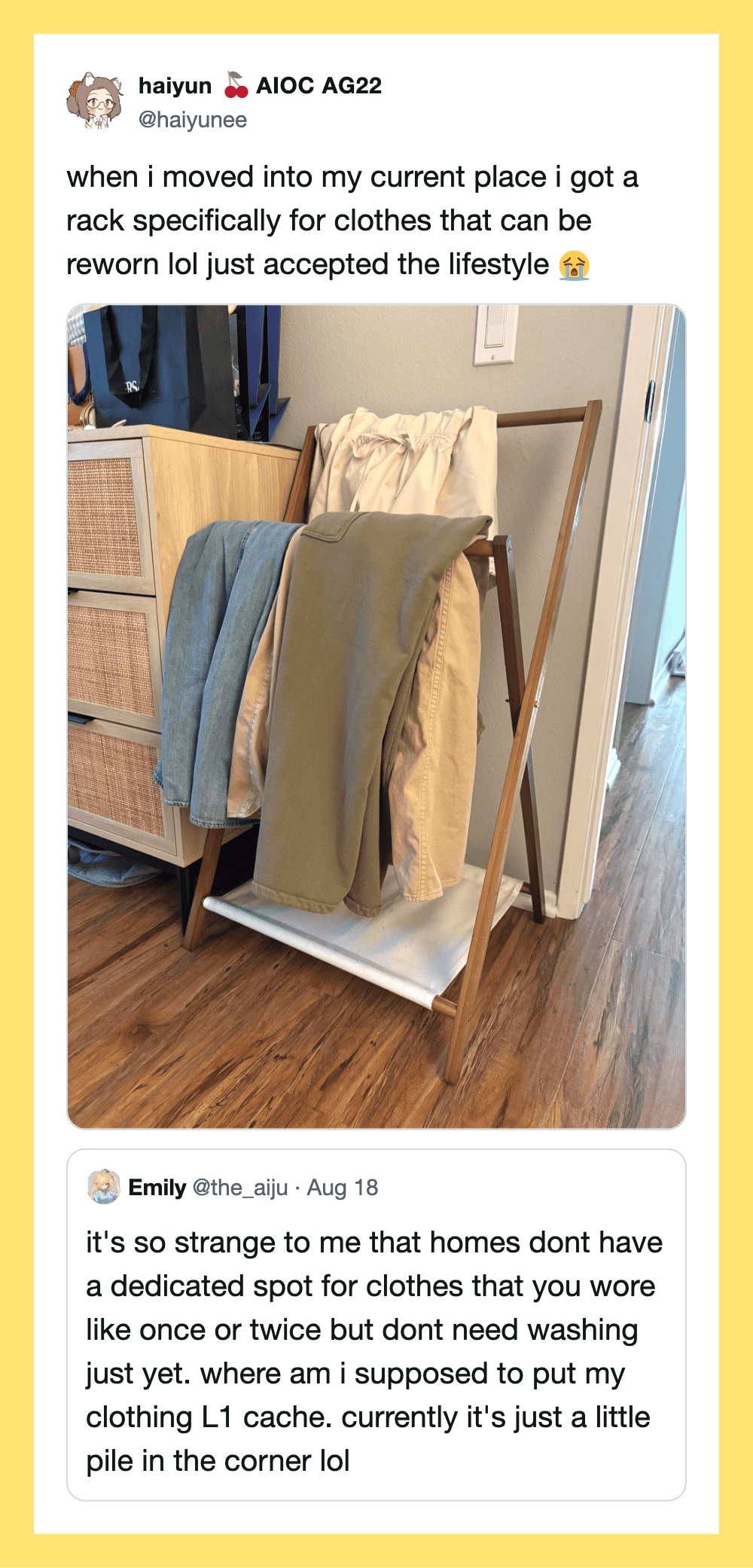 Clothes hanging on a rack in a corner of a room.