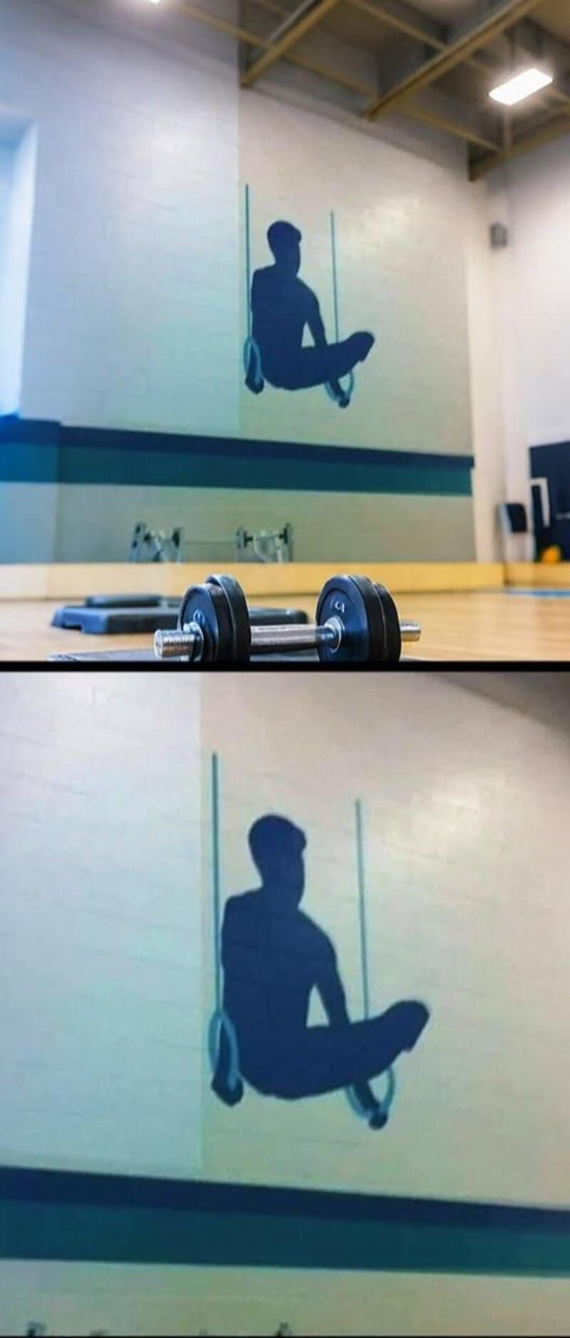 Silhouette of a person sitting on a swing painted on the gym wall.