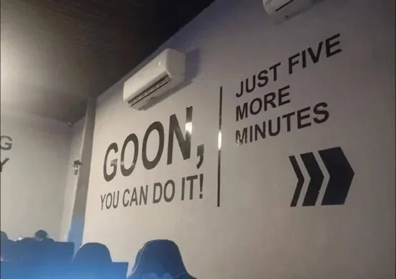 Goom, you can do it! Just five more minutes arrow sign on wall.