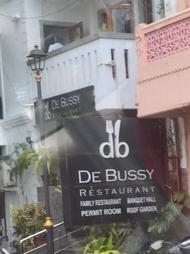 De Bussy restaurant sign with family restaurant, banquet hall, permit room, roof garden.