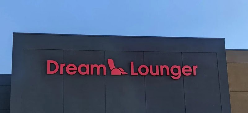 Dream Lounger sign with a chair icon replacing the letter 'L' in Lounger.