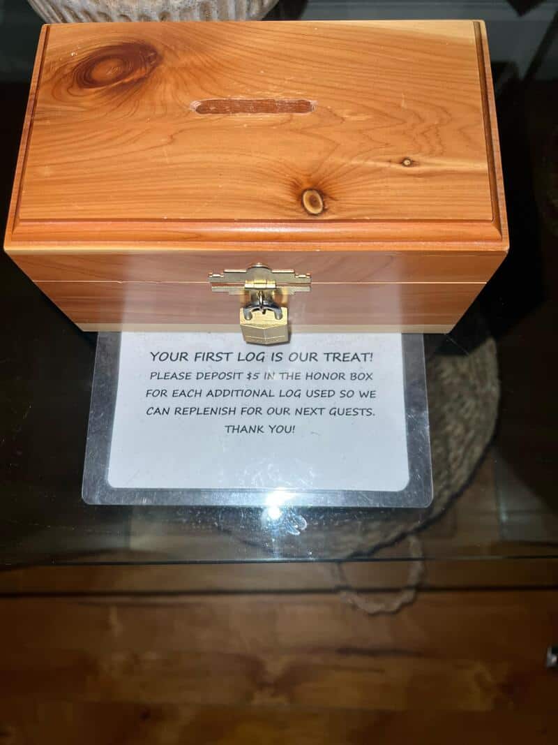 Wooden log box with a note about a treat and refill instructions.