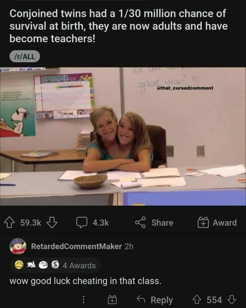 Two young girls hugging in a classroom with whiteboard and posters behind them.