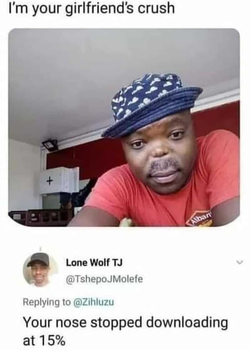A man wearing a blue patterned hat and red shirt with a humorous comment about his nose.