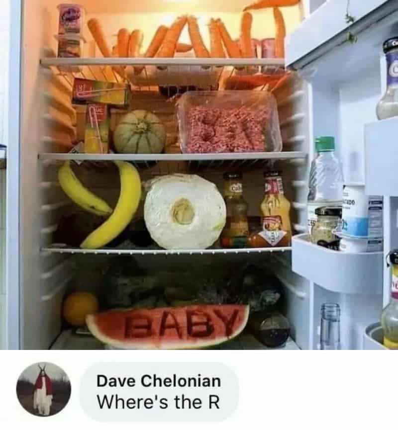 Inside a fridge with a watermelon, banana, and a watermelon slice with 'BABY' written on it.