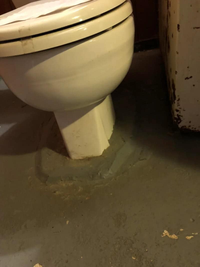 Toilet mounted on a concrete block, not properly installed.