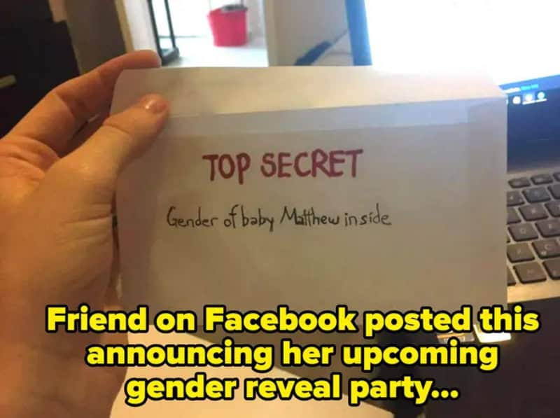 Top secret note about gender of baby Matthew inside, held by a hand.