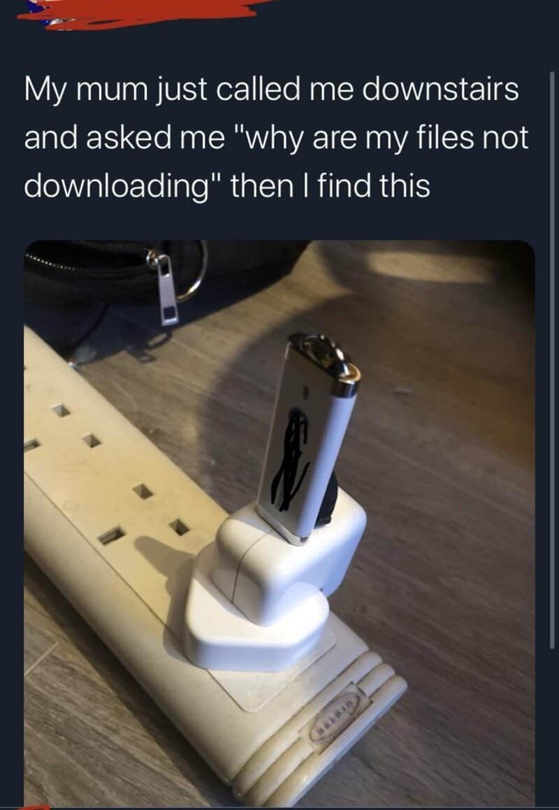 Humorous image of a USB stick in a charger with a caption about files not downloading.