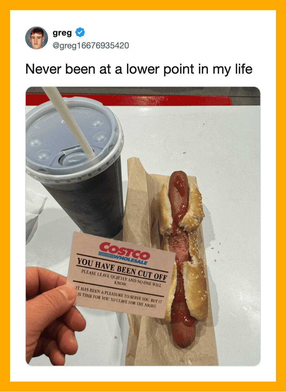 A hot dog with ketchup and mustard, a large soda, and a Costco cut-off receipt.