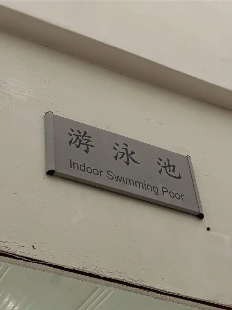 Indoor Swimming Pool sign with Chinese characters and English translation.