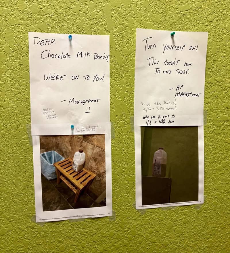 Notes on a green wall with a photo of a milk bottle and a note about fixing a broken sink.