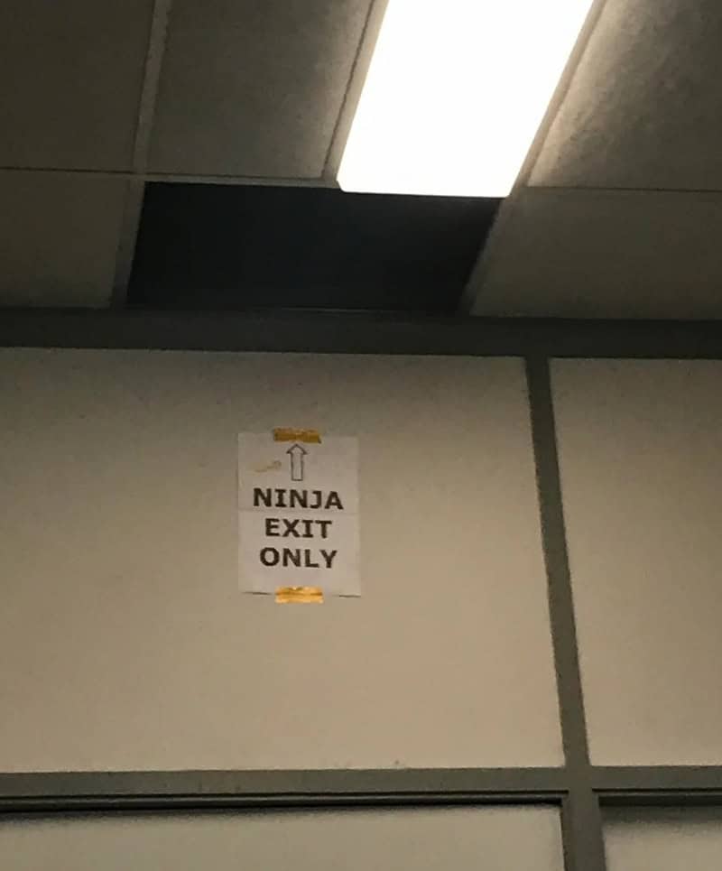 NINJA EXIT ONLY sign on a wall in a gym.