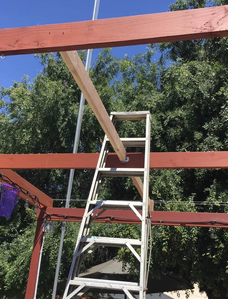 Ladder leaning against a wooden beam during home improvement work.