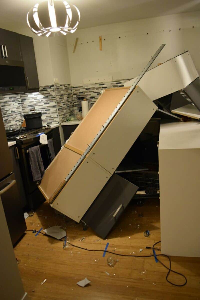 Fallen kitchen cabinets and appliances after a home improvement mishap.