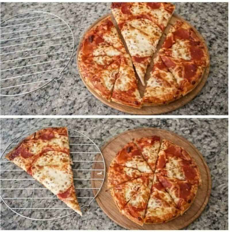Pizza slices on a wooden board and a wire rack on a granite countertop.