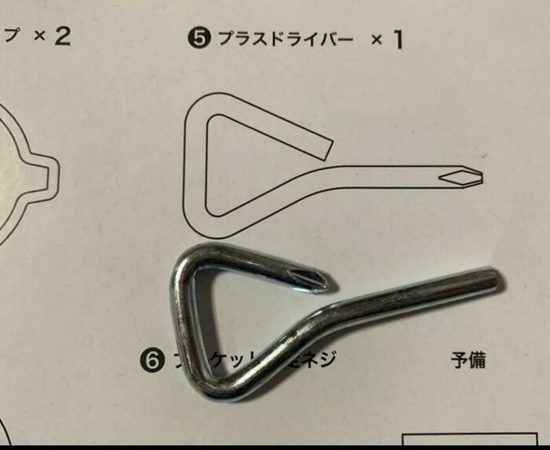 A metal hook placed on a paper with Japanese instructions and diagrams.