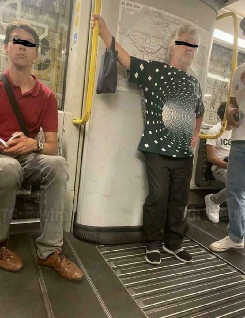 Woman with a digital distortion effect on her body standing in a subway.