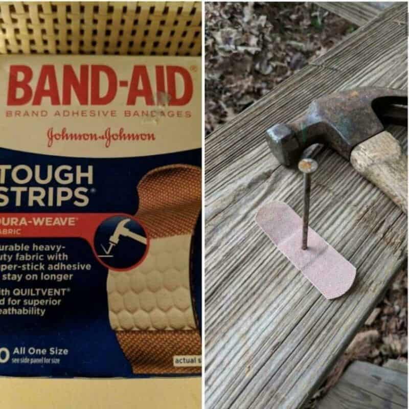 A Band-Aid package and a hammer with a nail on a wooden surface.