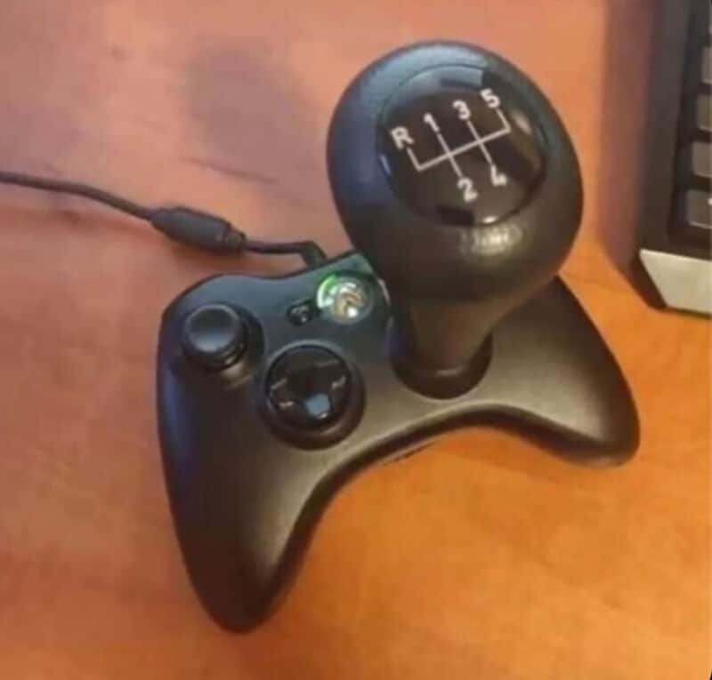 Game controller with a gear shift knob on top, resembling a car gear shift.