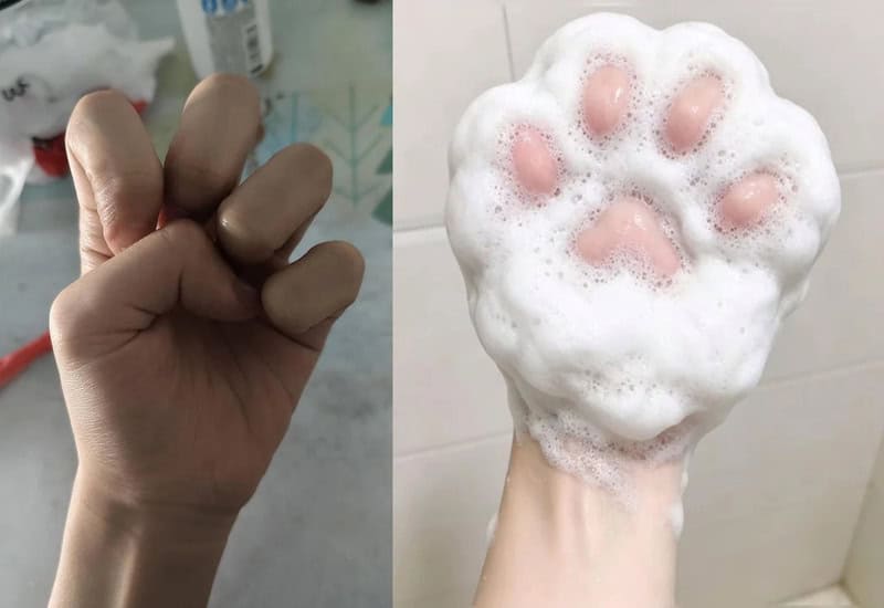 Fist with fingers curled, next to a soap paw print with pink pads and bubbles.