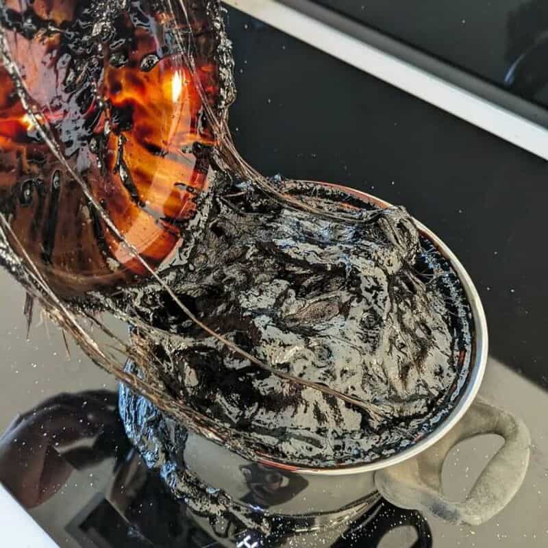 Burnt coffee mug with melted and charred contents, resembling a kitchen fail.