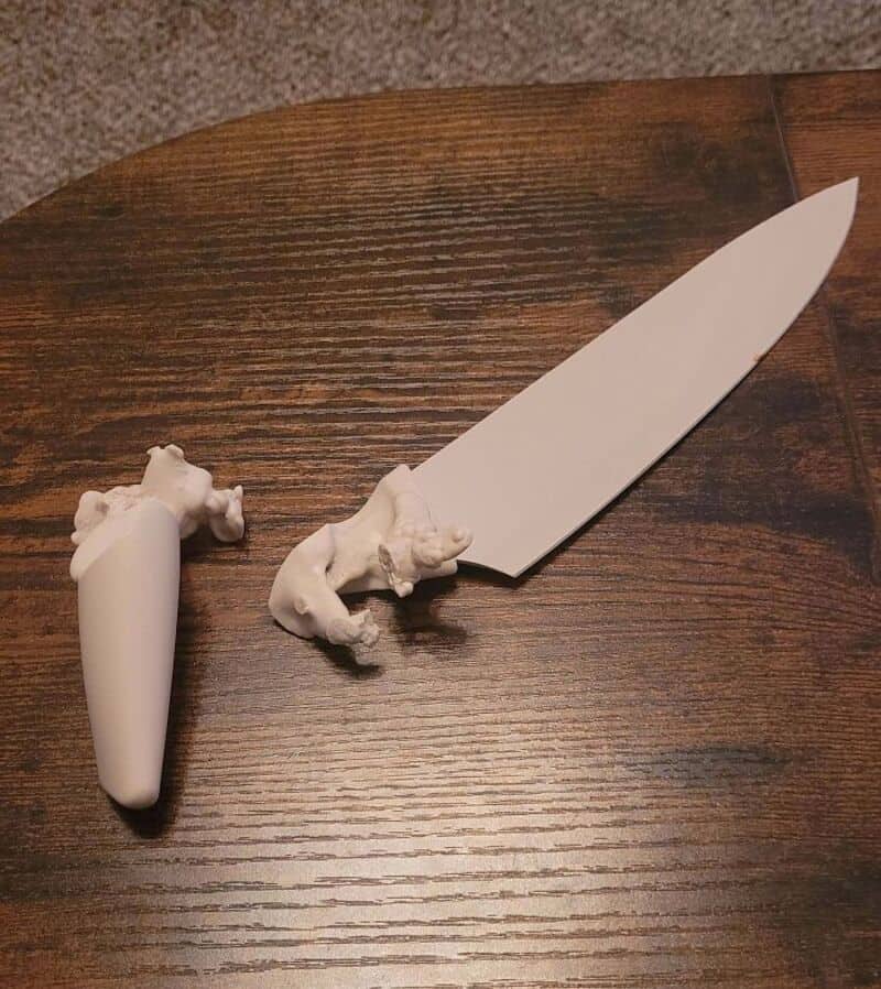 A knife with a handle made of a dog-shaped figurine and a blade with a dog-shaped figurine.