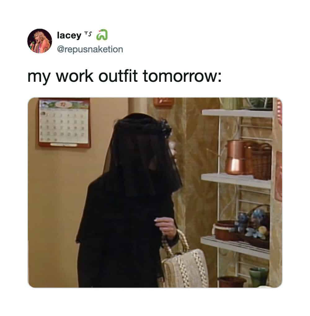 Person in black outfit with veil, holding a beige handbag, in a room with shelves and decor.