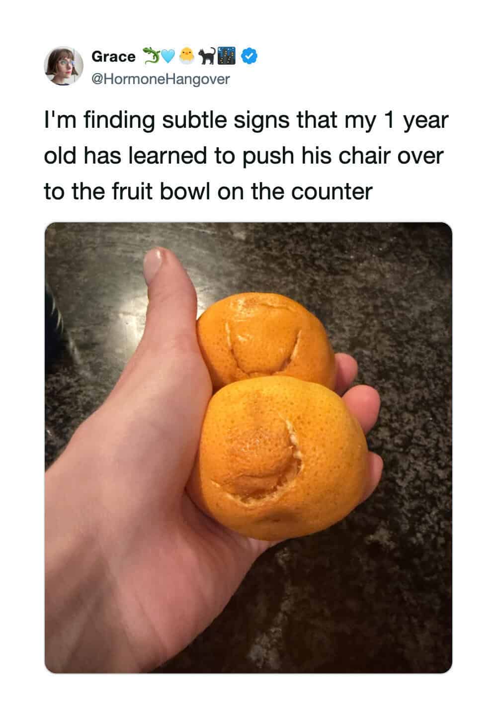Hand holding two peaches with subtle facial expressions, one with a smile and the other with a frown.