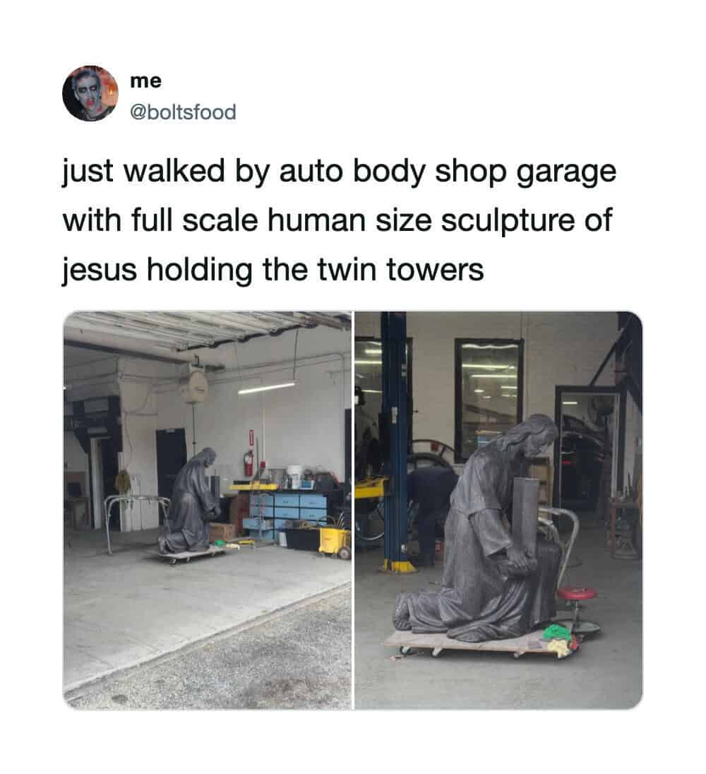 Full-scale sculpture of Jesus holding the twin towers at auto body shop garage.