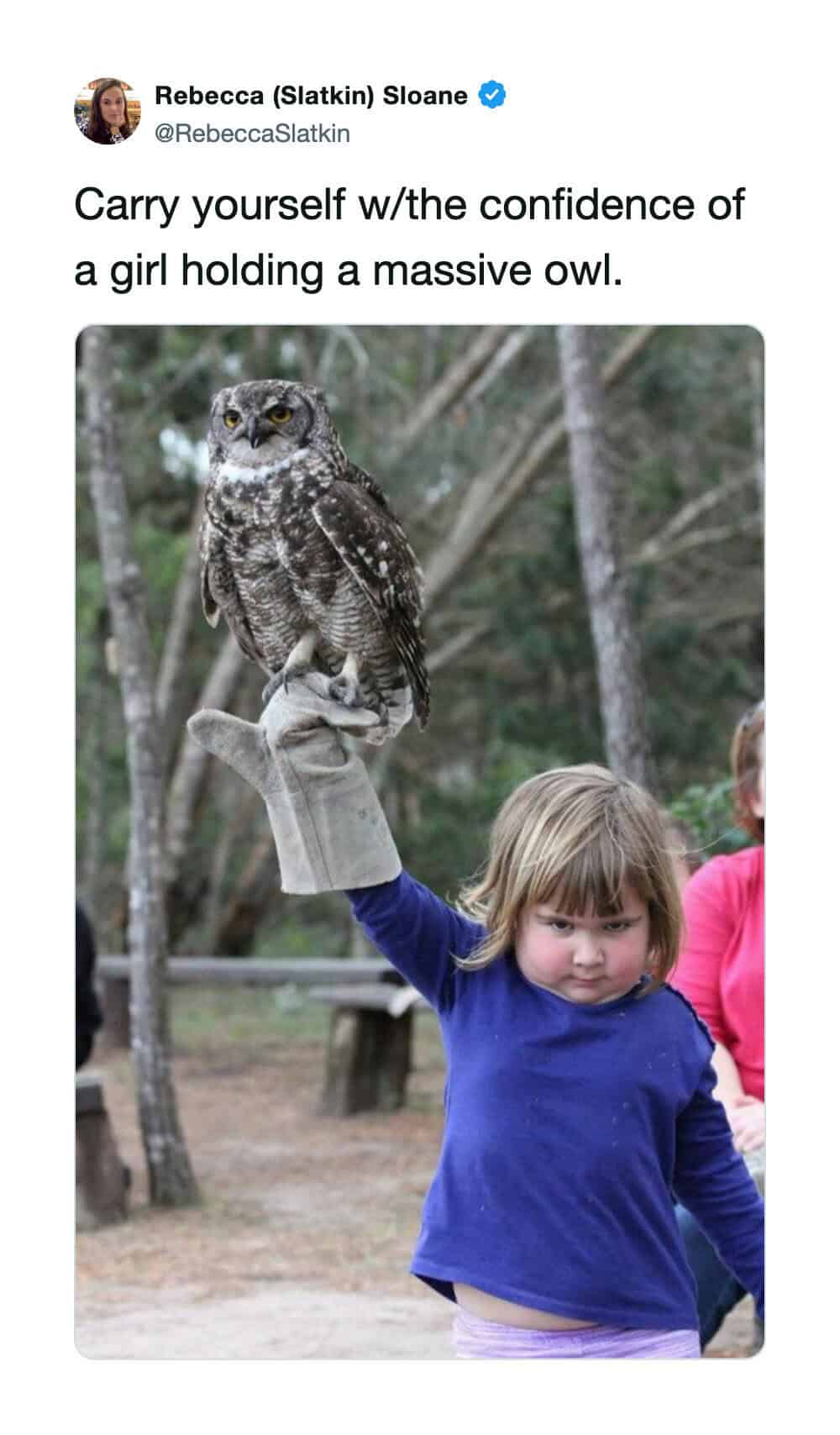 Girl holding a massive owl on her arm, confident and proud.