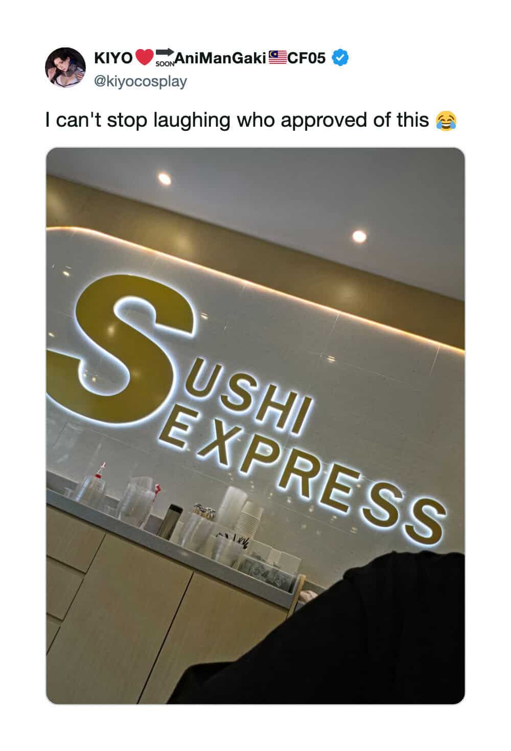 Sushi Express sign in a restaurant with a person partially visible in the foreground.