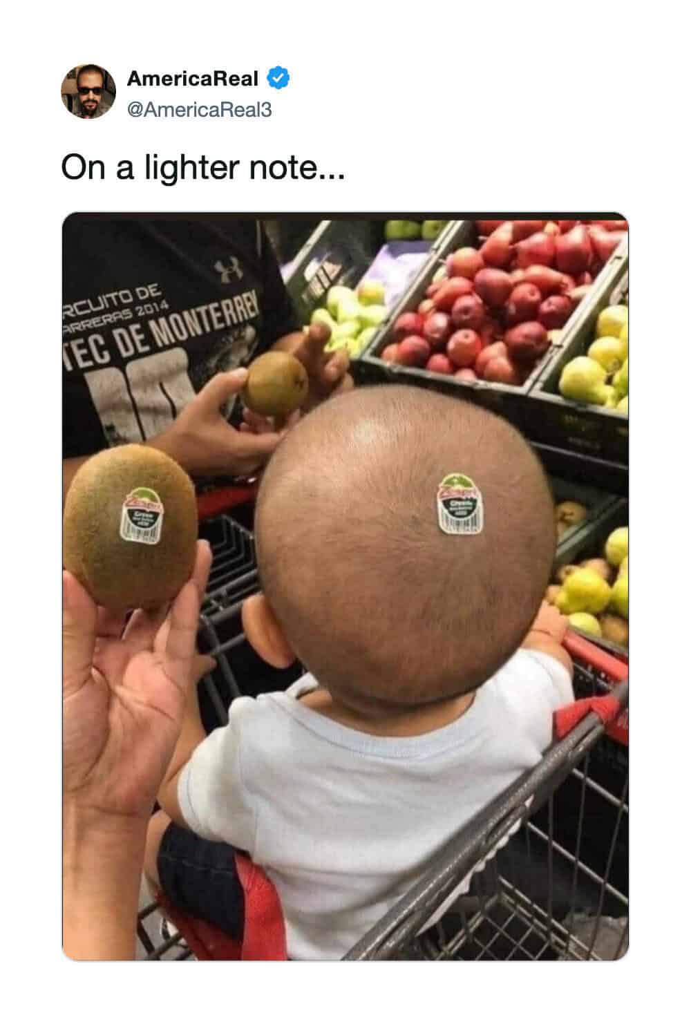 Person holding a kiwi and a melon in a grocery store, with a child's head in front.