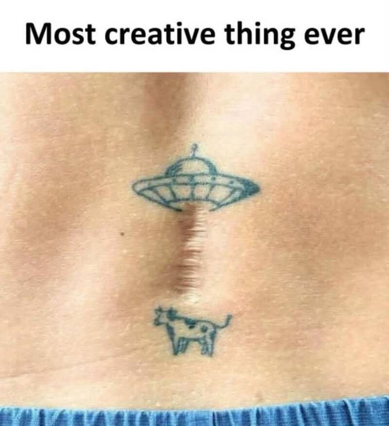 Tattoo of a UFO with a dog below it, with the caption 'Most creative thing ever'.