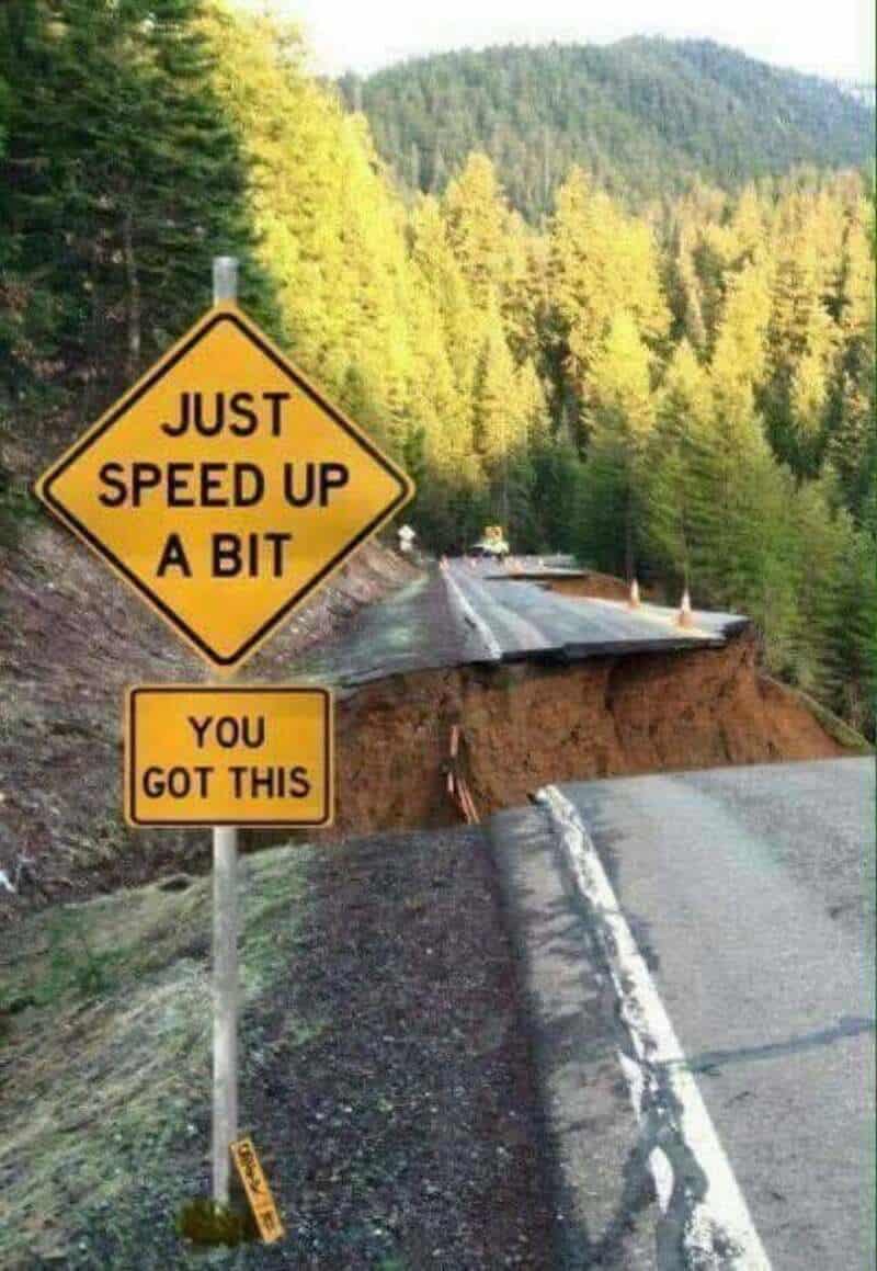 Road damage with a sign saying 'Just speed up a bit, you got this'.