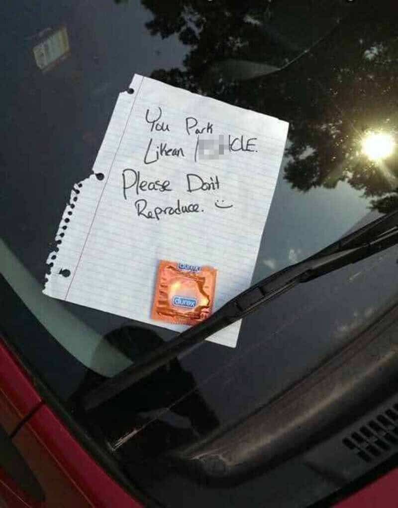 Note on car windshield says 'You Park Like a Jerk. Please Don't Reproduce.' with a condom packet.